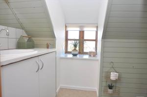 a bathroom with a sink and a window at 20038-Ulfborg-Knakvej-8 in Ulfborg +26 photos