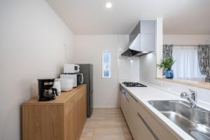 a kitchen with a sink and a counter top at Villa Gotemba Holidays in Gotemba