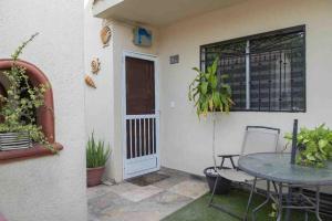 a patio with a table and chairs and a window at Casita Océano in La Paz