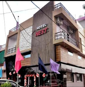a building with a hotel next sign on it at Hotel Nest in Nagda