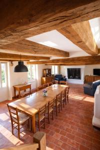 a dining room with a large wooden table and chairs at La longère du golf in Verneuil-sur-Indre