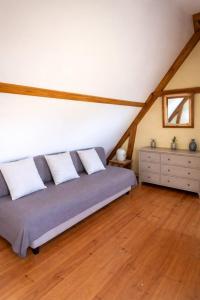 a bedroom with a bed with three pillows on it at La longère du golf in Verneuil-sur-Indre +4 photos