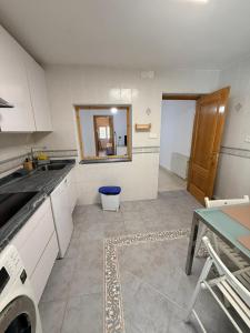a kitchen with a sink and a table and a mirror at Casa Pumba in San Martín de la Vega +8 photos