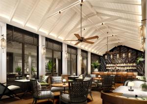 a restaurant with a ceiling fan and tables and chairs at THE BARAI HUA HIN - The Unbound Collection by Hyatt in Hua Hin