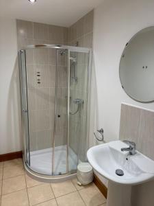 a bathroom with a shower and a sink at Ardbrae Apartments in Daviot +5 photos