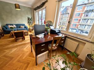 a living room with a desk with a computer on it at Spacious Home in Brussels in Brussels