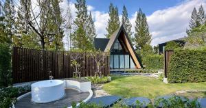 a house with a bath tub in a garden at Khunkhao Paradise Khao Yai in Ban Rai Khlong Sai +26 photos