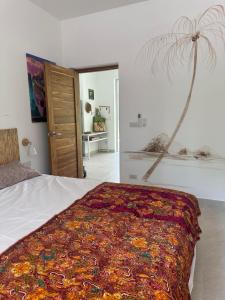 a bedroom with a bed with a colorful blanket on it at Villa Colette in Ban Hua Laem Ma So +34 photos