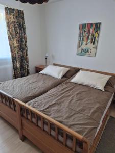 two beds in a bedroom with avertisement for at Haus Silberblick Anrig in Grächen