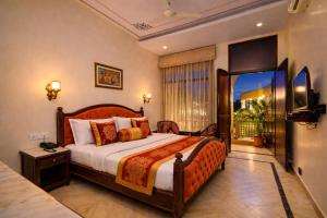 a bedroom with a large bed and a balcony at Harnawa Haveli - A Boutique Heritage Stay in Jaipur in Jaipur