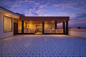 a house with a lit up patio at night at Harnawa Haveli - A Boutique Heritage Stay in Jaipur in Jaipur
