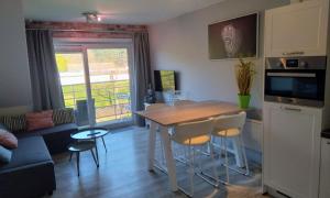 a kitchen and living room with a table and chairs at Just like home De Haan aan Zee in De Haan