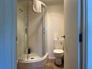 a bathroom with a shower and a toilet at Hampden Heaven in Hampden