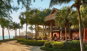 a resort with palm trees on the beach at THE BARAI HUA HIN - The Unbound Collection by Hyatt in Hua Hin