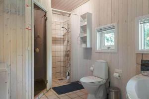 a bathroom with a toilet and a shower and a sink at 30816-Ulfborg-Oster-Skovvej-67 in Ulfborg +13 photos