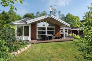 a house with a deck with a piano on it at 30816-Ulfborg-Oster-Skovvej-67 in Ulfborg