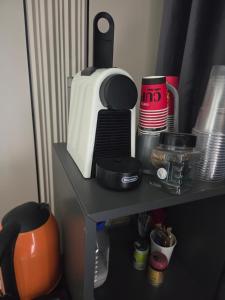 a table with a microwave and other kitchen items on it at Penthouse - 1st Line To The Sea in Bat Yam +18 photos