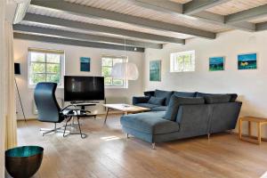 a living room with a couch and a tv at 20132-Ulfborg-Tyttebaervej-19 in Ulfborg