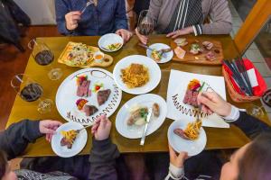 a group of people sitting at a table with plates of food at MONTIS HOTEL Hida Takayama in Takayama