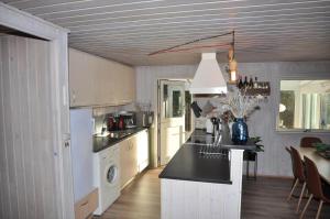 a kitchen with white cabinets and a black counter top at 30171-Ulfborg-Snerlevej-492 in Ulfborg +18 photos