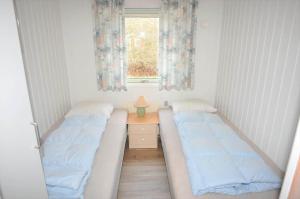 two beds in a small room with a window at 30171-Ulfborg-Snerlevej-492 in Ulfborg