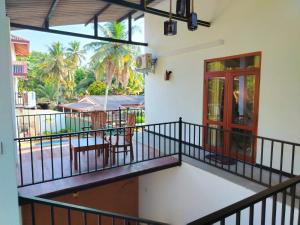 a balcony with a view of a pool at Robert Ayurveda Villa in Bentota