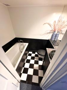 a bathroom with a black and white checkered floor at 4th Floor Bed and Breakfast in Warsaw +40 photos