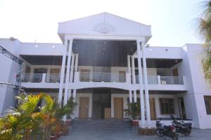 a building with two motorcycles parked in front of it at SHIVAAY GARDEN in Kannauj