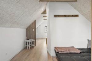 a living room with a black couch and a white wall at 70240-Ulfborg-Vesterhavsgade-12 in Ulfborg