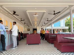 a group of people standing in a waiting room at Hotel Mathura Inn Shirdi in Shirdi