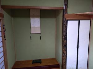 a room with two glass doors and a mirror at ペンション自給自足 in Miyazu