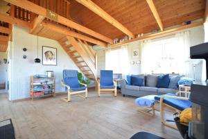 a living room with blue chairs and a couch at 20238-Ulfborg-Bankvej-1 in Ulfborg