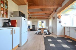 a kitchen with a white refrigerator and a table at 20238-Ulfborg-Bankvej-1 in Ulfborg +16 photos