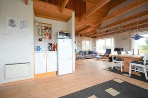 a living room with a refrigerator and a table at 20238-Ulfborg-Bankvej-1 in Ulfborg