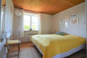a bedroom with a large bed and a window at 20238-Ulfborg-Bankvej-1 in Ulfborg