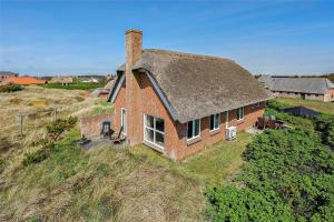 an aerial view of a brick house with a thatched roof at 20238-Ulfborg-Bankvej-1 in Ulfborg