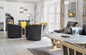 a living room with chairs and a table and a tableasteryasteryasteryasteryastery at 10607-Ulfborg-Gaffelbjergvej-38 in Ulfborg