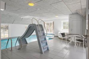 a room with a slide and a swimming pool at 10607-Ulfborg-Gaffelbjergvej-38 in Ulfborg