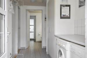 a white laundry room with a washer and dryer at 10607-Ulfborg-Gaffelbjergvej-38 in Ulfborg