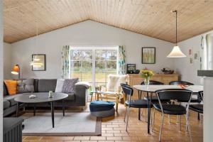 a living room with a couch and tables at 20733-Ulfborg-Sortebaervej-4 in Ulfborg