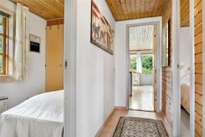 a bedroom with a bed and a door to a patio at 80011-Vemb-Harpotvej-84 in Vemb