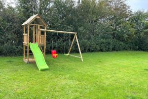 a playground with a slide and a swing at 80011-Vemb-Harpotvej-84 in Vemb