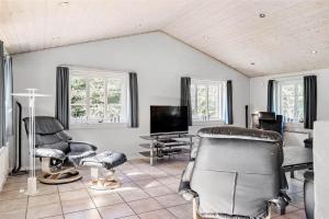 a living room with chairs and a flat screen tv at 10878-Ulfborg-Graemvej-31 in Ulfborg