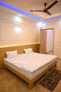 a large bed in a room with a ceiling at SHIVAAY GARDEN in Kannauj