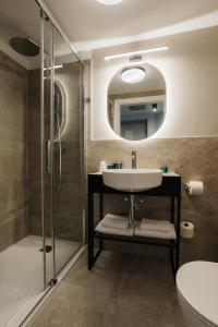 a bathroom with a sink and a shower at Hotel M4 Boutique in Krakow +31 photos