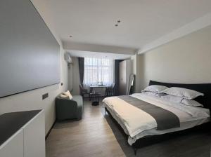 a bedroom with a large bed and a table at 梦息民宿 in Guyuan