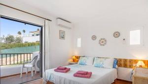 a bedroom with a bed and a balcony at Apartment for 6 with a private terrace in Son Bou in Son Bou +16 photos