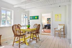 a dining room with a yellow table and chairs at 20033-Ulfborg-Vesterhavsvej-15 in Ulfborg
