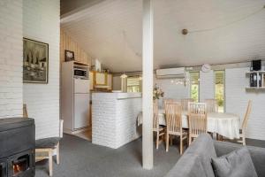 a kitchen and dining room with a table and chairs at 30705-Ulfborg-Valmuevej-288 in Ulfborg