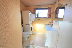 a small bathroom with a toilet and a refrigerator at 30061-Ulfborg-Kaprifolievej-6 in Ulfborg +15 photos